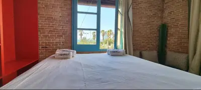 a large bed in a room with a brick wall at Barceloneta Mar Vela -BM14 in Barcelona