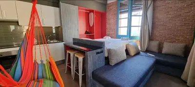 a room with a bed and a table and a kitchen at Barceloneta Mar Vela -BM14 in Barcelona