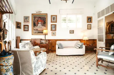 a living room with two chairs and a table at HomeHolidaysRentals Suria - Costa Barcelona in San Pol de Mar