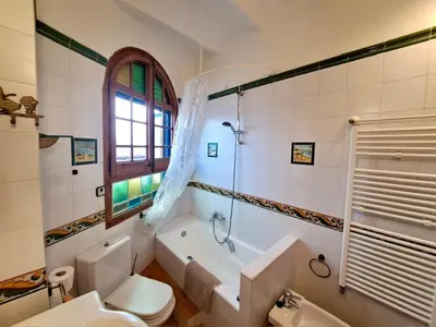 a bathroom with a tub and a toilet and a sink at HomeHolidaysRentals Suria - Costa Barcelona in San Pol de Mar