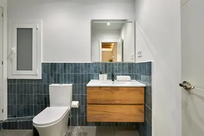 a bathroom with a toilet and a sink and a mirror at Ro Lively and bright apartment next to Blai st in Barcelona