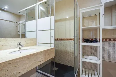 a bathroom with a sink and a shower at Gran Via City Center Apartment in Barcelona