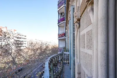 a balcony of a building with a fence at Gran Via City Center Apartment in Barcelona