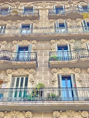 a building with windows and balconies on it at Gran Via City Center Apartment in Barcelona
