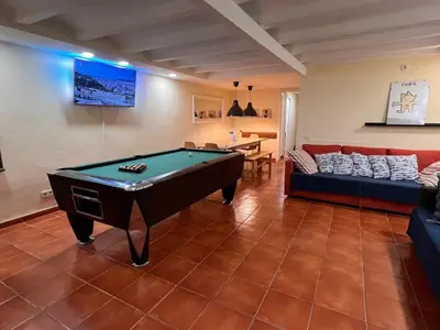 a living room with a pool table and a couch at Ramblas Rentals Central Duplex 4BR Terrace Pool Table & Ping Pong in Barcelona