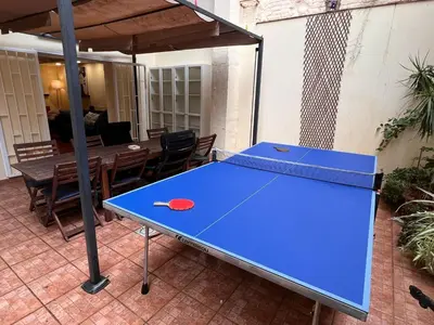 a blue ping pong table on a patio at Ramblas Rentals Central Duplex 4BR Terrace Pool Table & Ping Pong in Barcelona