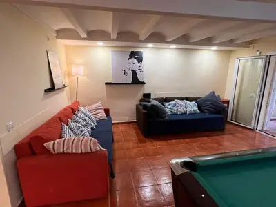 a living room with a couch and a pool table at Ramblas Rentals Central Duplex 4BR Terrace Pool Table & Ping Pong in Barcelona