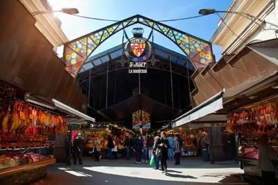 a group of people walking through a market at Ramblas Rentals Central Duplex 4BR Terrace Pool Table & Ping Pong in Barcelona