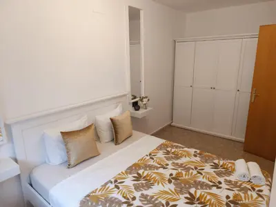 a bedroom with a large white bed with pillows at CasaKech in Vilanova i la Geltrú