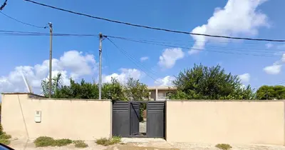 a house with a black gate on a wall at CasaKech in Vilanova i la Geltrú