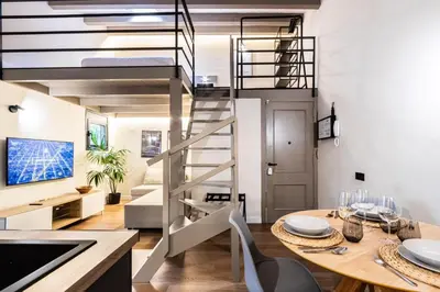 a kitchen and dining room with a spiral staircase at Petit Luxe Del Vall in Terrassa