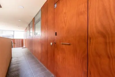 a hallway with wood paneled walls in a building at Petit Luxe Mutua in Terrassa