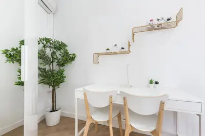 a white dining room with a white table and chairs at Barcelona Central Park II in Barcelona
