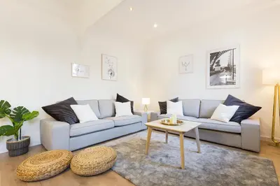 a living room with two couches and a table at Barcelona Central Park II in Barcelona