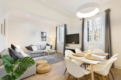 a living room with a table and chairs and a couch at Barcelona Central Park II in Barcelona