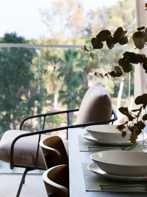 a table with chairs and plates on a table with a window at Durlet Suites by Durlet Apartments in Barcelona