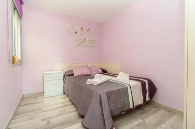 a small bedroom with a bed and a dresser at Side Sea Cunit sea views in Cunit
