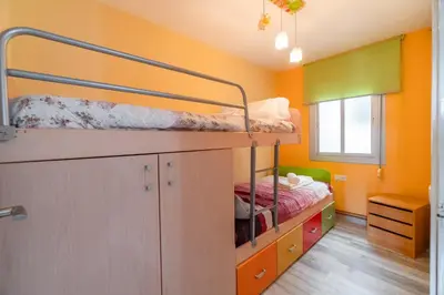 a small room with two bunk beds and a window at Side Sea Cunit sea views in Cunit