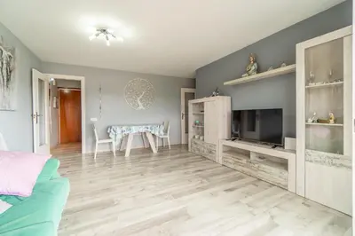 a living room with a table and a television at Side Sea Cunit sea views in Cunit