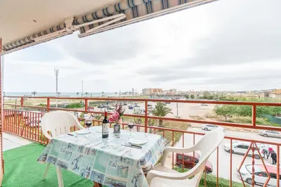 a table on a balcony with a view of the ocean at Side Sea Cunit sea views in Cunit