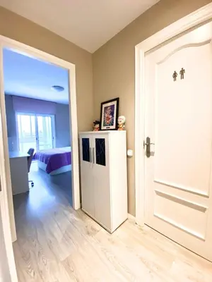 a room with a white door and a bedroom at Precioso apartamento al lado de Barcelona centro in Sant Feliu de Llobregat
