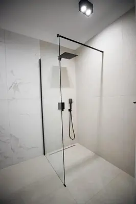 a shower with a glass door in a room at My White Vilanova Home in Vilanova i la Geltrú