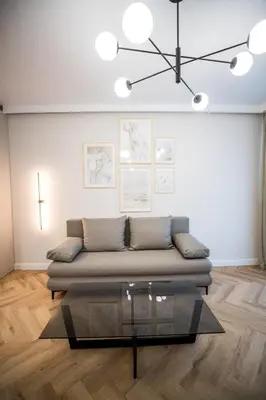 a living room with a couch and a glass table at My White Vilanova Home in Vilanova i la Geltrú