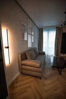 a living room with a couch and a television at My White Vilanova Home in Vilanova i la Geltrú