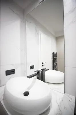 a white bathroom with two sinks and a mirror at My White Vilanova Home in Vilanova i la Geltrú