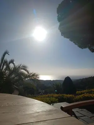 a view of the ocean with the sun in the sky at Parc du Montnegre avec magnifique vue mer in Tordera