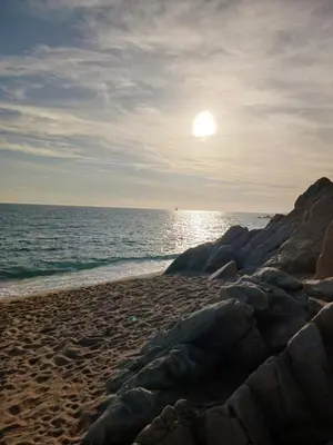 a beach with the sun rising over the ocean at Parc du Montnegre avec magnifique vue mer in Tordera