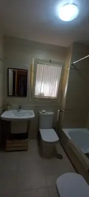 a bathroom with a sink and a toilet and a tub at Piso in Hospitalet de Llobregat