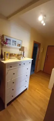 a white dresser with a lamp on top of it at Piso in Hospitalet de Llobregat