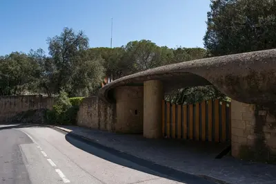 a stone bridge over a road next to a street at Casakubrick mansión in Castelltersol