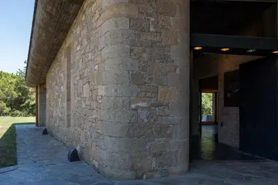 a brick wall of a building with a doorway at Casakubrick mansión in Castelltersol