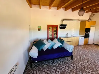 a bedroom with a bed with blue sheets and pillows at La Casita Soler The Soler Cottage in Arbós