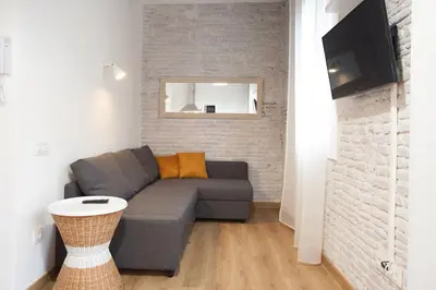 a living room with a couch and a tv at Flat with balcony next to the beach, SV in Barcelona