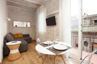 a living room with a couch and a table at Flat with balcony next to the beach, SV in Barcelona