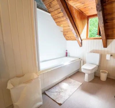 a bathroom with a toilet and a tub and a window at Apartamento montaña en Arties in Artés