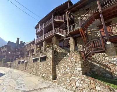 a stone building with balconies on the side of it at Apartamento montaña en Arties in Artés