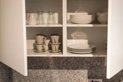 a cupboard filled with plates and bowls and dishes at Happy People Sagrada Familia Apartments in Barcelona