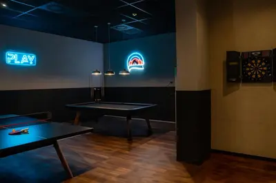 a room with two ping pong tables and neon signs at BLAU Student Housing - Students Only in Barcelona