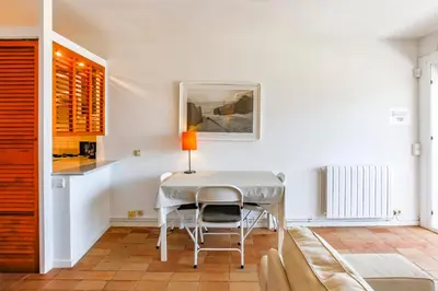 a dining room with a table and a couch at Penelope Apart in Sitges