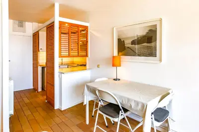 a dining room with a white table and chairs at Penelope Apart in Sitges