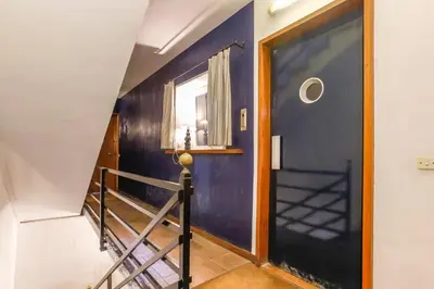 a hallway with a blue wall and a staircase at Penelope Apart in Sitges