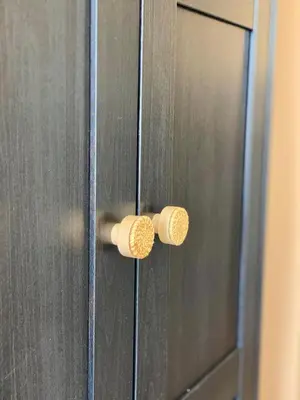 a wooden door with two wooden knobs on it at LEB Apartments in Pineda de Mar