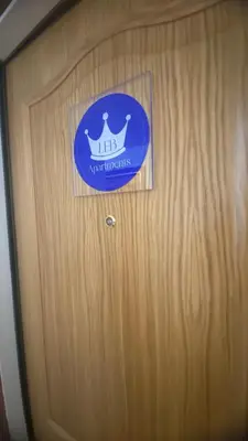 a wooden door with a sign on it at LEB Apartments in Pineda de Mar