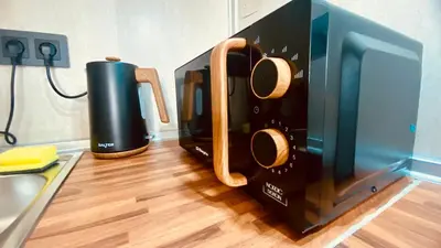 a microwave oven sitting on top of a kitchen counter at LEB Apartments in Pineda de Mar
