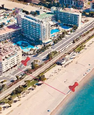 an overhead view of a beach with buildings and the ocean at LEB Apartments in Pineda de Mar