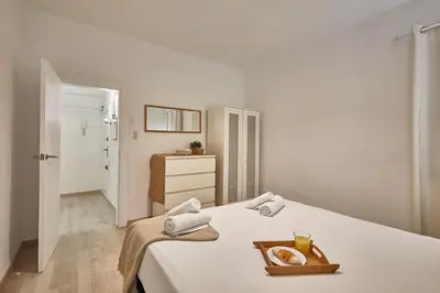a bedroom with a bed with a tray of food on it at BBarcelona Encants Flat in Barcelona